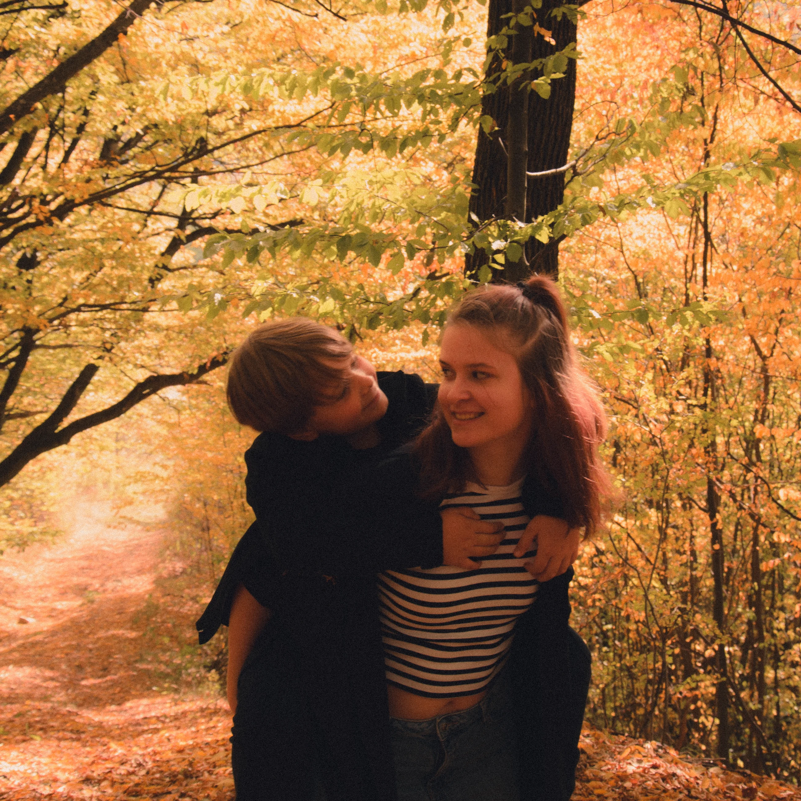 Two people embracing in autumn woodland
